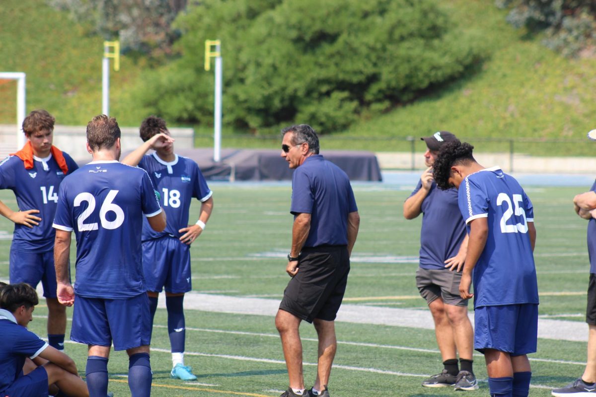 Coach Ray Talia talks to team after opener loss. 