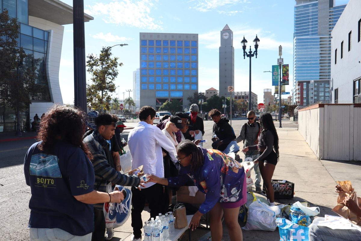 Volunteers with YoungBlackQueens drive distribute essentials to the community during the October 27, 2024 event in downtown San Diego.